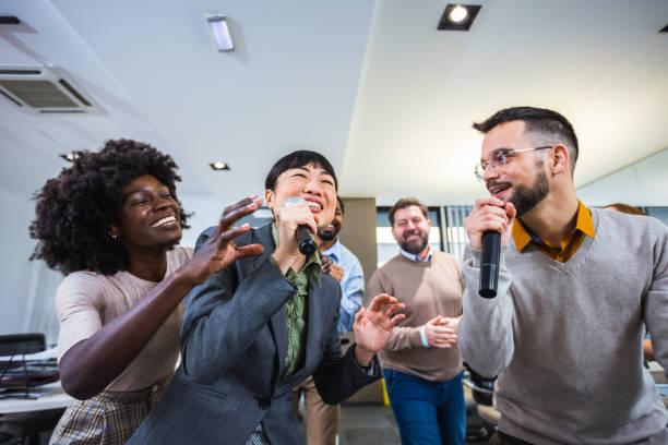 istock Multiethnic colleagues having karaoke party in the office. 2076285340