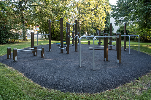 A sporty public playground featuring a horizontal slide, monkey bars, balancer, and modern climbing frame, in a private sector area in Prague.