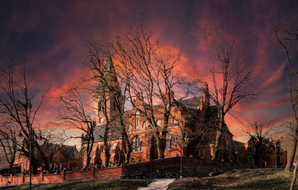 Gothic medieval church and cemetery and a setting sun. Mysterious place and dramatic sky
