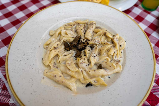 fuzi istrian pasta with black truffle tartufo mashroom and cream traditional food in Rovinj Croatia .