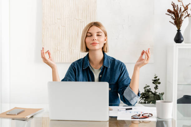 istock Relaxed young woman meditating at workplace after working day shift. Work life balance concept. 2076351796