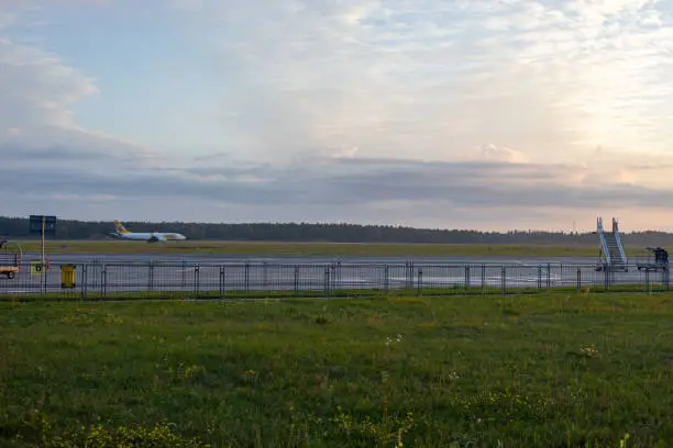Empty Modlin airport in Poland in the morning with Ryanair stairs and blurred landing aircraft