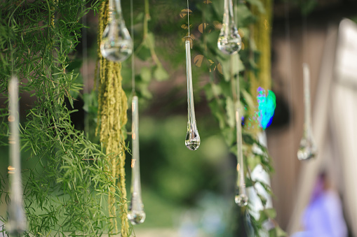 Hanging glass and shiny beads are an element of the wedding decor.