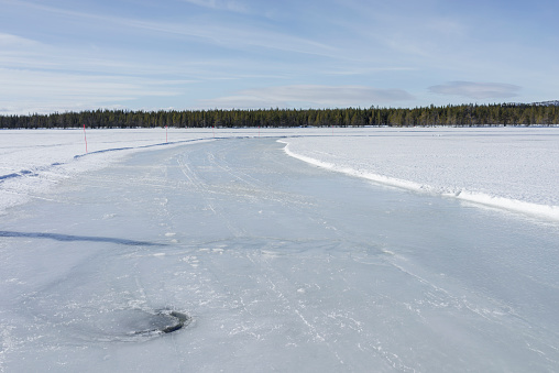 This picture shows a frozen lake in Sweden in winter, February 2014. A snowplow was used to make tracks for cars on the frozen lake. The tracks are then used for Ice Driving Experience and also cars can drift.