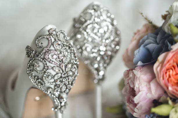 istock Brides wedding shoes with a bouquet with roses 2076454216