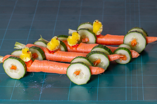 Creative with vegetables. Carrot racing cars with Easter chicks. healthy food and carrot racing cars. Which Easter chick will win the big carrot race?