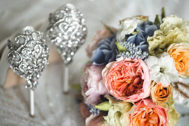 istock Brides wedding shoes with a bouquet with roses 2076470769