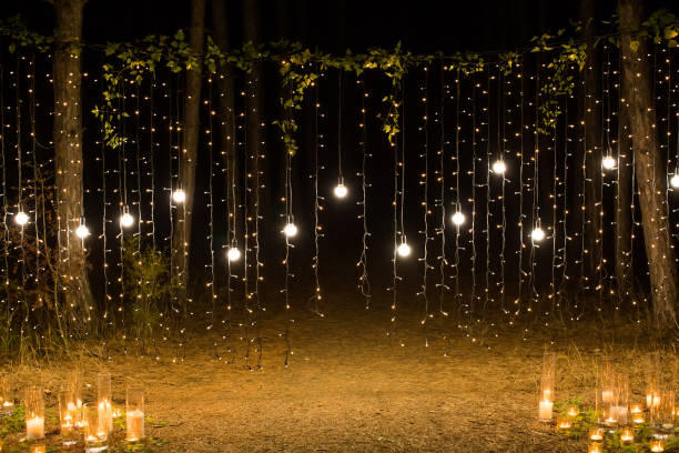 istock Wedding ceremony evening with candles and lamps in the coniferous pine forest 2076477976