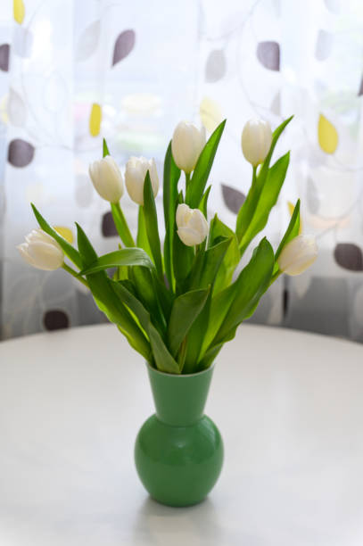 bouquet of tulips and Easter bunny on white table. copy space