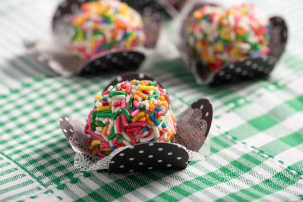 istock Brigadeiros, beautiful colorful sweets on a green and white tablecloth, selective focus. 2076499325