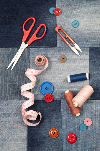 Sewing kit on Blue denim fabric background