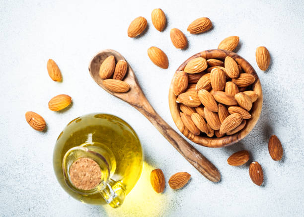 istock Almond nuts in wooden bowl at white background. 2076511581