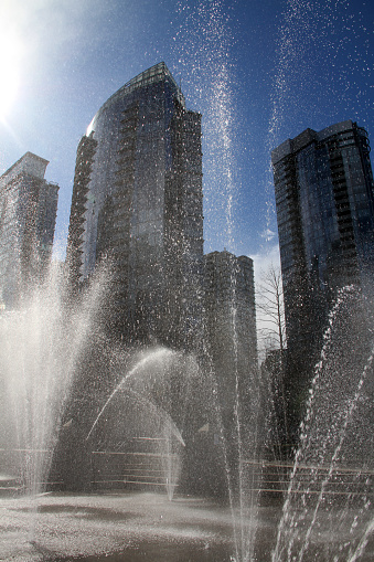 Downtown Vancouver through a fountain.