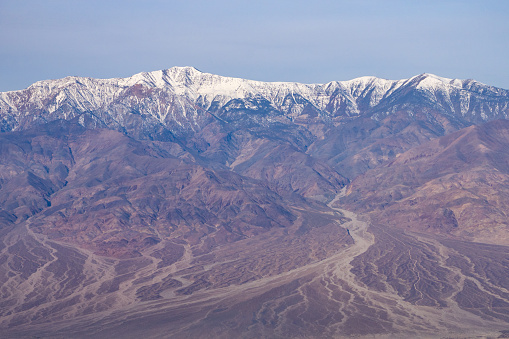 Lake Manly forming in Badwater Basin after heavy rains in Death Valley National Park. Salt flats, snowcapped mountains,  and desert valley views seen from Dante's View.