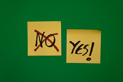 No and yes yellow notes over green background