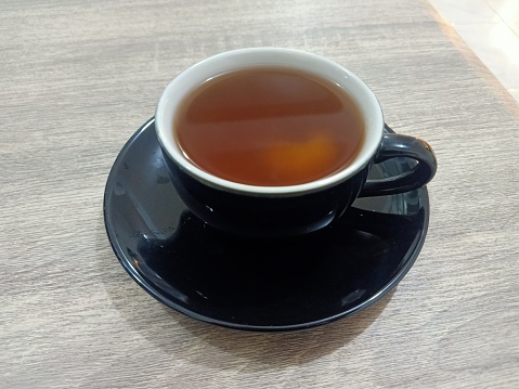 Hot tea in black glass