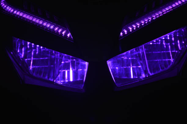 The front LED light of a purple automatic motorbike