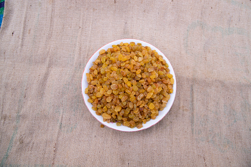 Top view of Delicious heathy raisins on the Jute fiber fabric