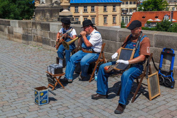Group of musicians playing on Charles Bridge (Karluv most), the historical buildings of Lesser Town Bridge tower (Mala Strana district), Prague, Czech Republic