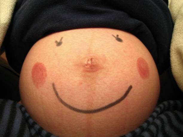 Children with there father holding there pregnant mother