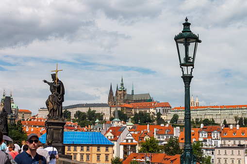 Tourists and the Statue of Saint John Baptist, Charles Bridge (Karluv most), St Vitus Cathedral, Prague, Czech Republic