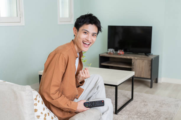istock asian young man watching TV 2076884967