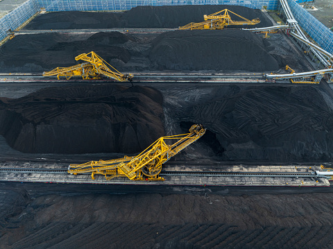 Drone view coal suction machine for Van Phong thermal power plant on a field of coal - Khanh Hoa province, central Vietnam