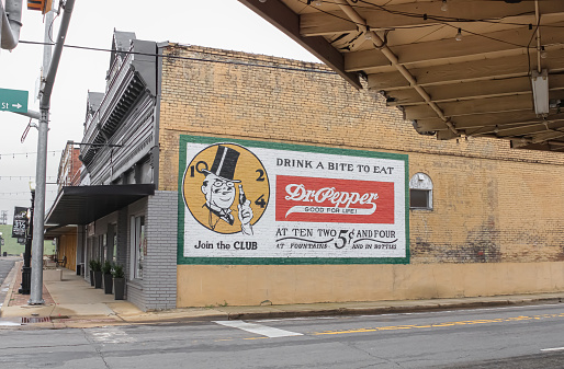 An old advertisement on a yellow building in Pittsburg, Texas