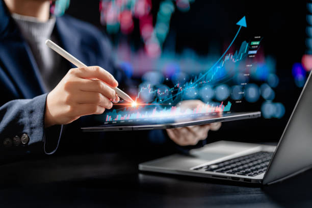 istock Businesswomen use tablets digital to analyze virtual screens of graph stock market changes, uptrends, growth economics, business strategy development, and find opportunities for investment. 2076890247