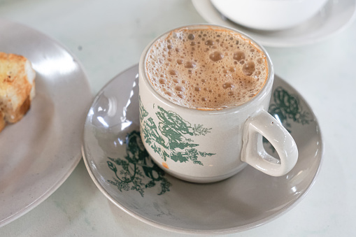 Popular drink in Malaysia called Teh Tarik. It is a sweet drink made from tea with milk.