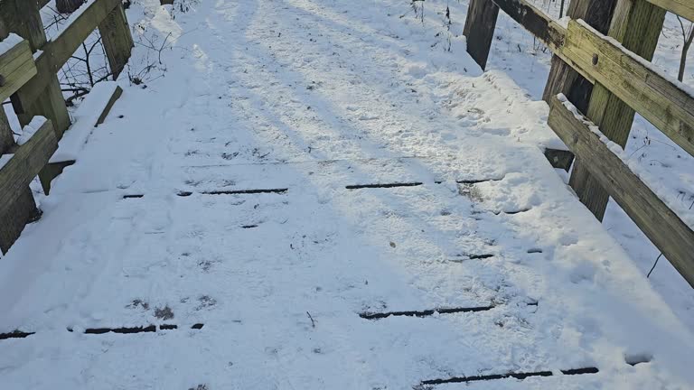 Walking over snowy boardwalk in winter season