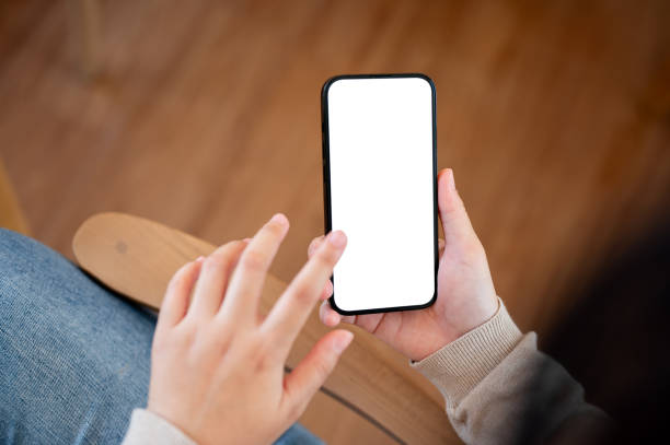 istock A white screen smartphone mockup to display your graphic ads is in a woman's hand. 2077007366