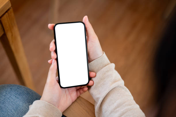 istock A white screen smartphone mockup to display your graphic ads is in a woman's hand. 2077007853