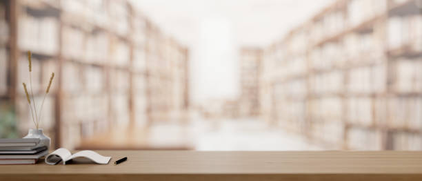 istock A wooden table features a presentation space with a blurred library in the background. 2077010975