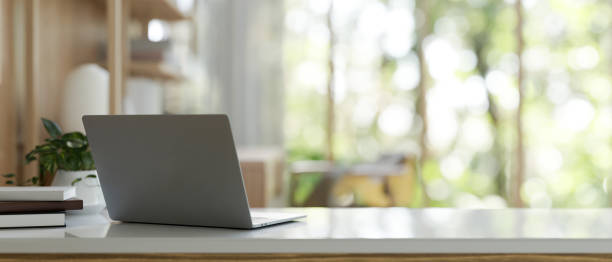 istock A back view image of a modern workspace in a bright office features a laptop computer on the table. 2077014561