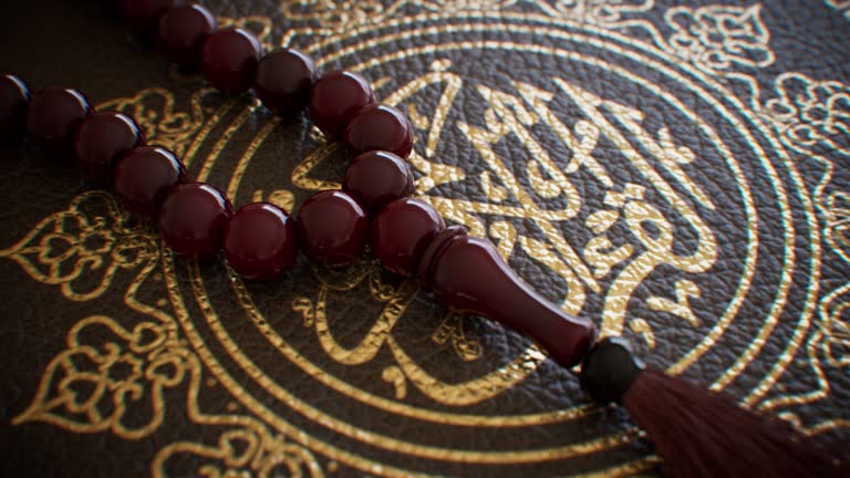 Wooden rosary beads on a religious book