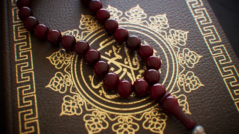 Wooden prayer beads placed on a religious manuscript