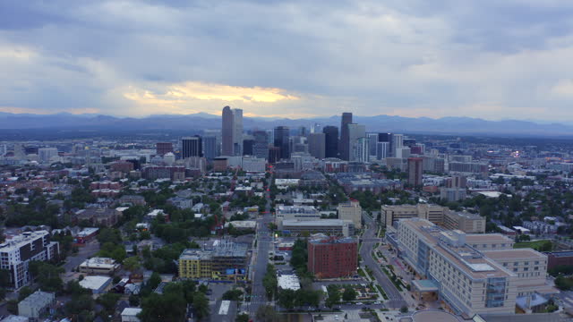 City Park Denver Colorado aerial drone Thomas Jefferson High School cloudy gray afternoon sunset spring summer downtown city skyline scenic landscape neighborhood Rocky Mountains forward motion