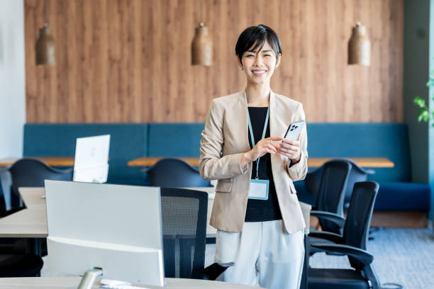 istock Business woman with smartphone in office 2077296851
