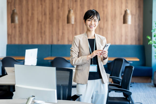 istock Business woman with smartphone in office 2077297391