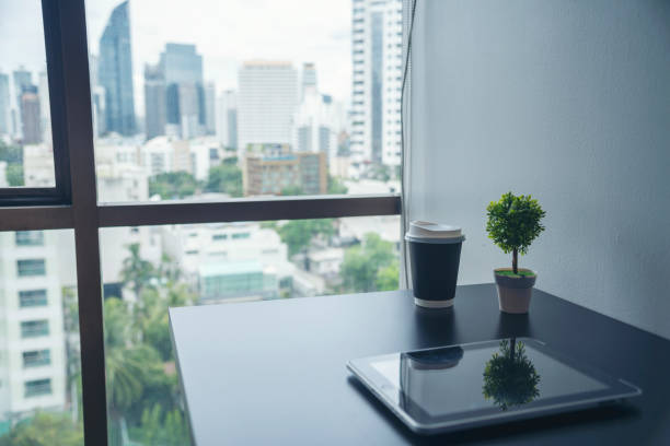 istock Top view office desk laptop and coffee cup on wood table copy space. Tabletop notebook laptop coffee cup for officer display empty space on wooden background. Home business work from home workspace 2077314365