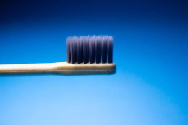 Natural Wooden toothbrush on blue background, health care, copy space