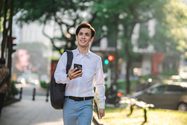 istock Young businessman using his smartphone on the street. 2077359582
