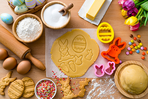 Overhead view of ingredients and utensils used for preparing Easter cookies at home. High resolution 42Mp studio digital capture taken with SONY A7rII and Zeiss Batis 40mm F2.0 CF lens