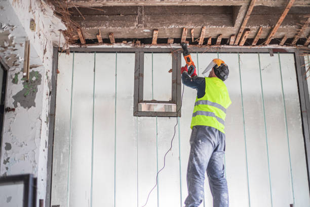 istock Renovation concept, construction worker demolishing ceiling in apartment 2077363290