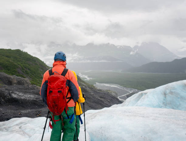 istock People hiking on ice at Exit Glacier. High mountains and deep valleys in the distance. Seward. Alaska. 2077393436
