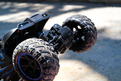 Toys Photography. Closeup Toys. Macro photo Front and Rear View of RC (Remote Control) Car. There are lights, car wheels, suspension and bumpers. Shot with a macro lens