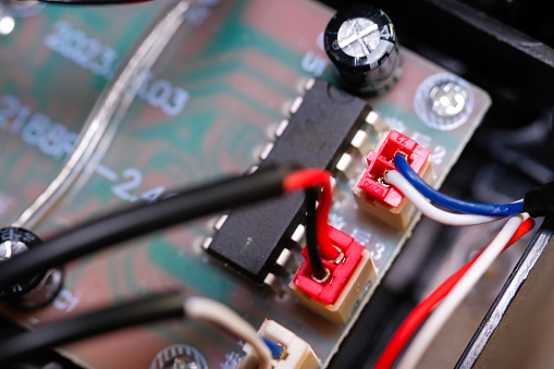 Macrophotography. Electrical closeup. Close up shot of the electrical circuit in an RC (Remote Control) Car. Background texture of PCB boards, cables, sockets and electronic devices. Shot with a macro lens