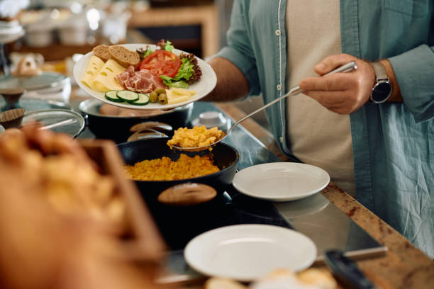 Close up of man having breakfast in the morning at hotel restaurant.