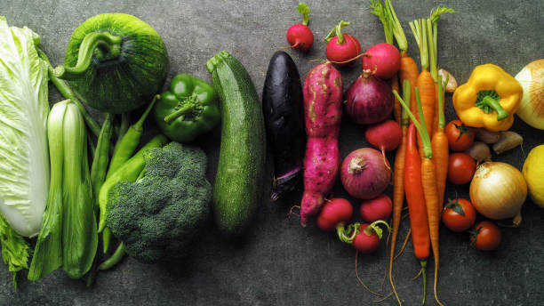 istock Large selection of fresh multicolored healthy vegetables on a mottled grey background. 2077444894